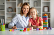 © Prostock-studio - Portrait of happy little girl and child development specialist lady