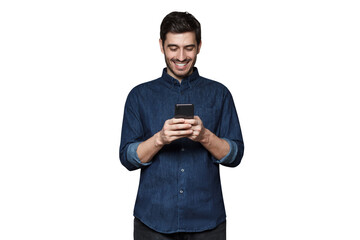 young man smiling and laughing as he is browsing internet or communicating via phone