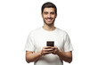 Handsome smiling man looking at camera while holding his smart phone, isolated on gray background