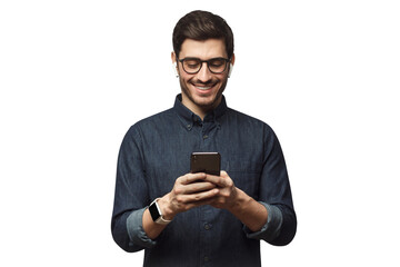 Wall Mural - Happy young man in blue denim shirt looking at phone, surfing the web