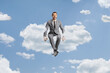 © Ljupco Smokovski - Businessman in a grey suit sitting on a cloud and smiling