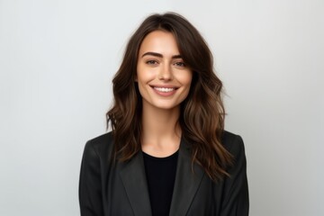 Medium shot portrait photography of a satisfied woman in her 30s that is wearing a sleek suit against a white background . Generative AI