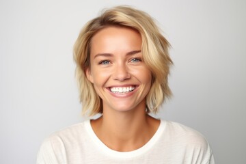 medium shot portrait photography of a grinning woman in her 30s that is placed against a white backg