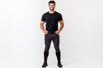 Wall Mural - Full length portrait of a handsome young man in black t-shirt posing on a white background.