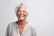 Portrait of a happy senior woman smiling at the camera on white background