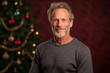 © Robert MEYNER - Portrait of a senior man in front of a christmas tree