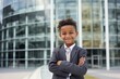 child boy that is wearing a suit and tie against a modern corporate office background