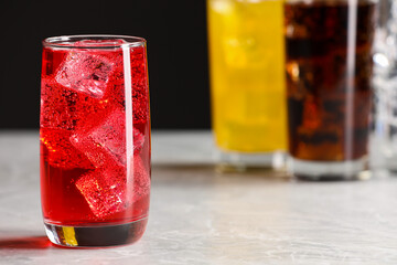 Sticker - Glass of refreshing soda water with ice cubes on white table, closeup. Space for text