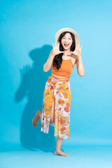 Wall Mural - image of cheerful smiling asian woman in swimsuit, isolated on blue background