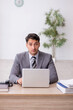© Elnur - Young male employee working in the office