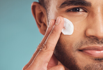 portrait, beauty and cream with a man in studio on a gray background to apply antiaging facial treat