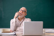 © Elnur - Old male teacher sitting in the classroom