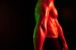 Man bodybuilder athlete posing muscle with nude torso in athletic, isolated on black background in neon light. Advertising, sports, active lifestyle, colored light, competition, challenge concept. 