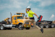 © Volodymyr - Hispanic 40 s builder excited jump on site construction. Excited builder construction worker in a safety helmet jumping in front of the trucks. Excited crazy builder man in helmet jump outdoor.