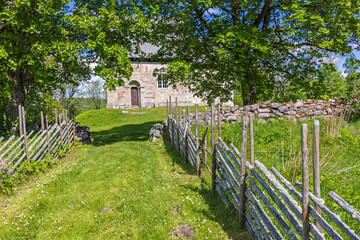 Canvas Print - Footpath with wooden pole fence to Suntak's old church in Sweden