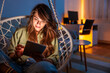 Woman relaxing at home reading an ebook