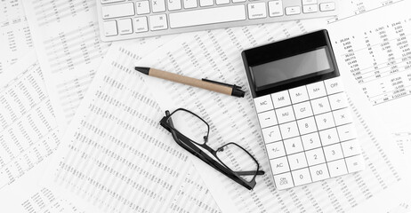 Poster - Calculator, keyboard and eyeglasses lying on financial statement . Financial concept.