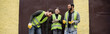 © LIGHTFIELD STUDIOS - Positive multiethnic workers in high visibility vests and gloves talking while standing near door of waste disposal station outdoors, garbage sorting and recycling concept, banner