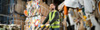 © LIGHTFIELD STUDIOS - Bearded sorter in high visibility vest and gloves standing near hand pallet truck while standing near waste paper in blurred garbage sorting center, waste sorting and recycling concept, banner