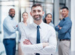 © Michael Cunningham/peopleimages.com - Smile, business people in portrait with team leader and confidence at project management company. Teamwork, commitment and vision, happy team with manager and arms crossed in corporate startup office