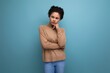 © Ivan Traimak - young pretty hispanic lady with afro curly hair in casual clothes posing against background with copy space
