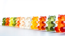 Bright gummy bear candy in a row. Various colors taste sugar sweet kids dessert. Gelatin gum jelly soft glowing bears close up focus photo