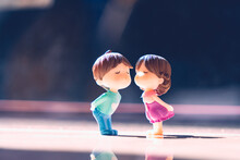 Miniature Boy Kiss Girl On Blurry Background Using As Family And Valentine's Day Concept