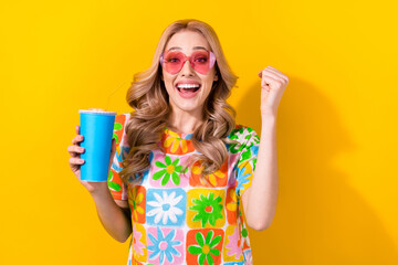 Wall Mural - Photo glad lady drink soda cup delighted cheap cinema prices wear heart sunglass print shirt isolated yellow color background