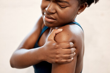 Canvas Print - Fitness, injury and black woman with shoulder pain during exercise at sports studio, massage and relief. Gym, hand on arm muscle for support and African girl with body ache during training or workout