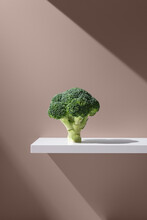 Green Broccoli On White Plain Surface
