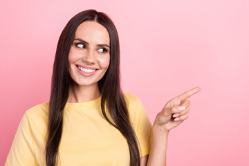 Poster - Photo of dreamy adorable lady wear yellow t-shirt showing finger looking empty space isolated pink color background