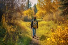 Young Man Walking In Autumn With His Backpack On Forest Path Generative AI