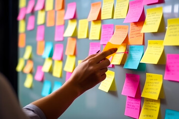 Woman putting on sticky note on wall, strategic business planning, very organized thinking. Generative AI