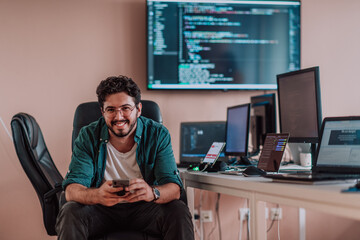 A programmer diligently testing smartphone applications while sitting in their office.