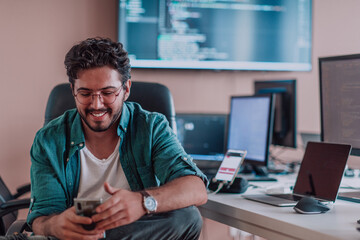 A programmer diligently testing smartphone applications while sitting in their office.