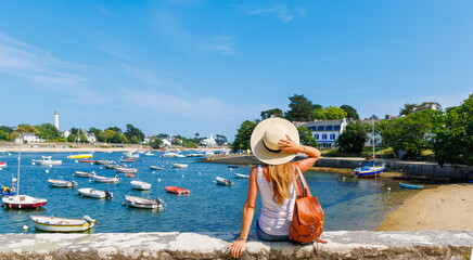 Wall Mural - Tourism in Brittany- Woman tourist enjoying view of Sainte Marine city and port-Finistere, Combrit- France