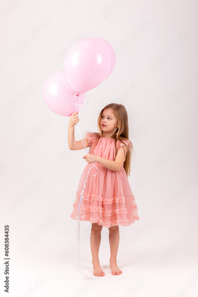 Foto Cute smiling little girl in a pink princess dress posing with air ...