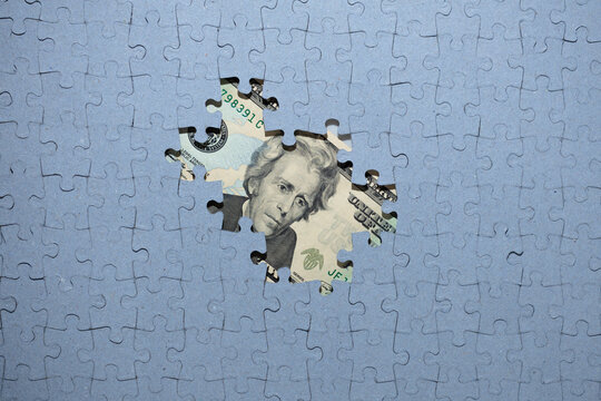 Wall Mural - default concept, missing puzzle pieces on top of US dollar banknote, concealment of income, default concept,