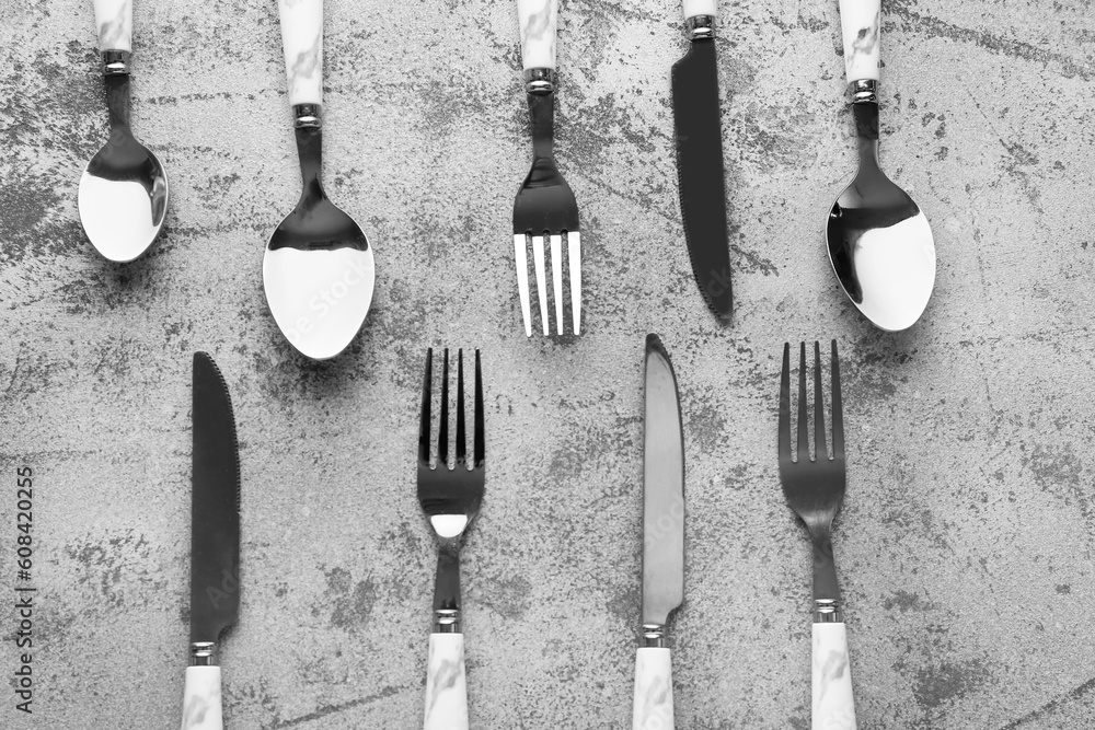 Silver cutlery on grey grunge background