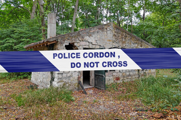 South African police tape barricading an abandoned stone house