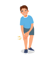 Wall Mural - Young man suffering from knee pain holding his injured leg while exercising