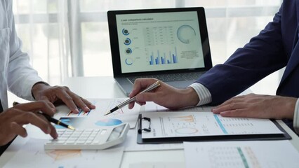 Wall Mural - Asian businessman working in the office, calculating financial reports, organizing paperwork using a laptop and calculator as an aid. management concept accounting.	