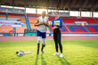 © Kawee - Portrait of Asian para-athlete disabled and trainer standing in stadium.
