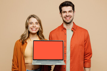Wall Mural - Young happy couple two friends family IT man woman wear casual clothes hold use work on blank screen laptop pc computer together isolated on pastel plain light beige color background studio portrait.