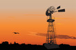 © Designpics - Silhouette of a vintage water pumping windmill against sunset sky
