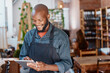 © Oostendorp/peopleimages.com - Restaurant, tablet and black man or small business owner, e commerce and online cafe or coffee shop management. Waiter or happy person reading sales on digital technology or internet for his startup