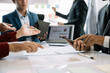 © NINENII - Businessmen team or financial data analysts working with tablets and laptop computers and data graphs together. Plan to analyzing projects in the office.