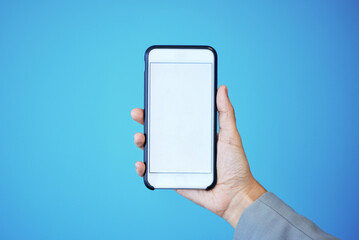 Wall Mural - person, phone and hand with mockup screen for advertising or marketing against a blue studio backgro
