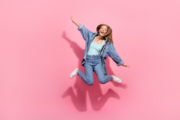 Wall Mural - Full length photo of cheerful stylish girl wear denim clothes fly air hands wings enjoy summer holiday isolated on pink color background