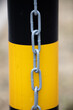 Security metal chain on black and yellow post